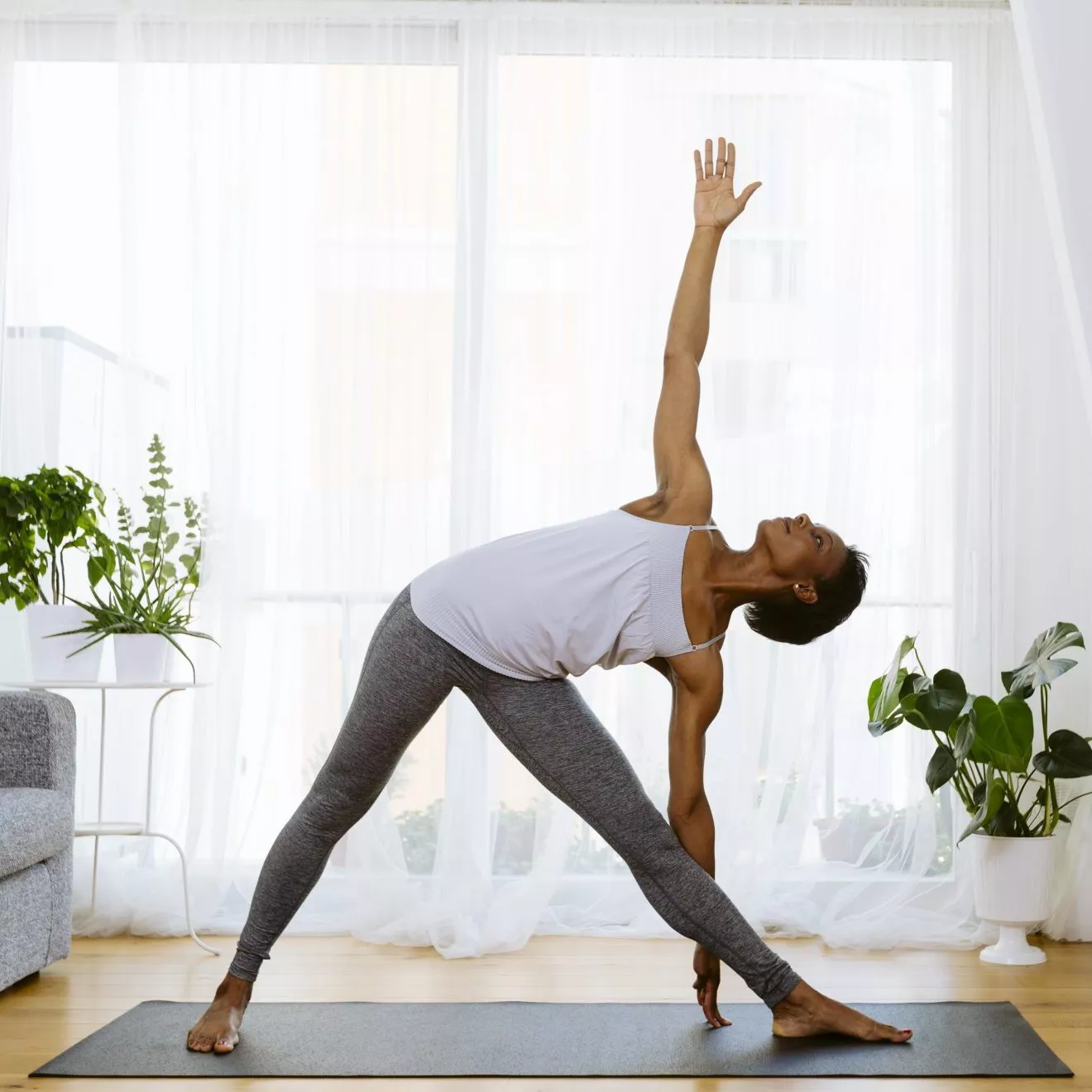 Woman practicing yoga at home as workout motivation