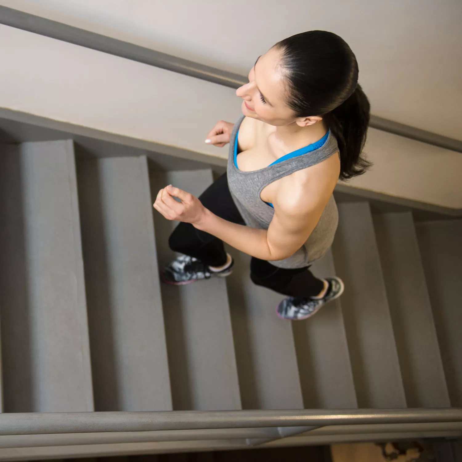 Stairs workout, stair exercises at home - trainer intro/warm-up (woman working out on stairs inside)