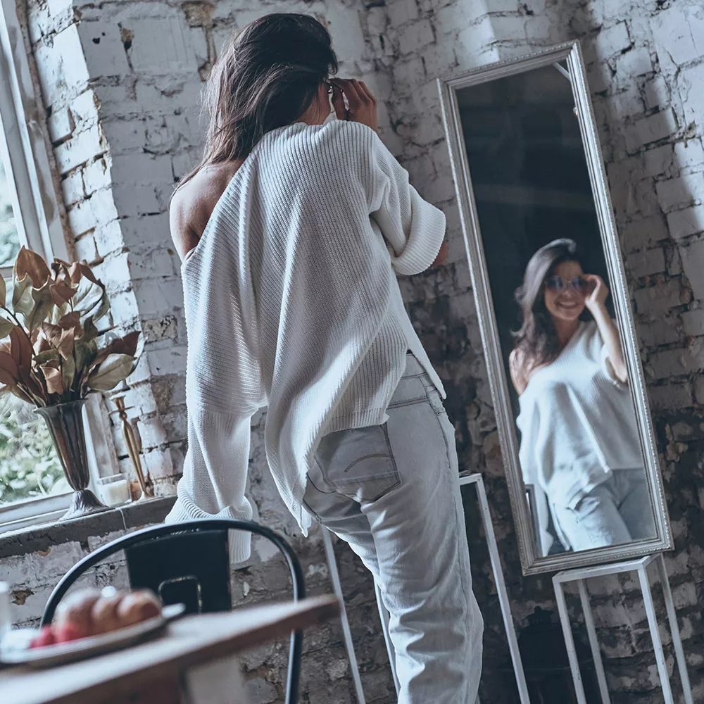 woman using mirror for weight loss motivation